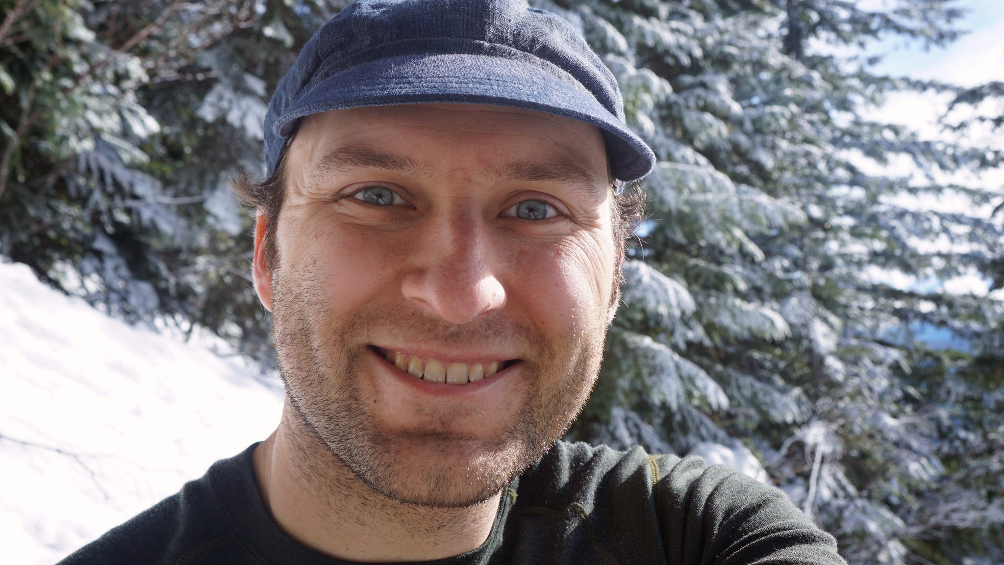 Self portrait in the snow wearing a blue cap